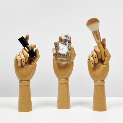 Wooden hand models holding cosmetics.
