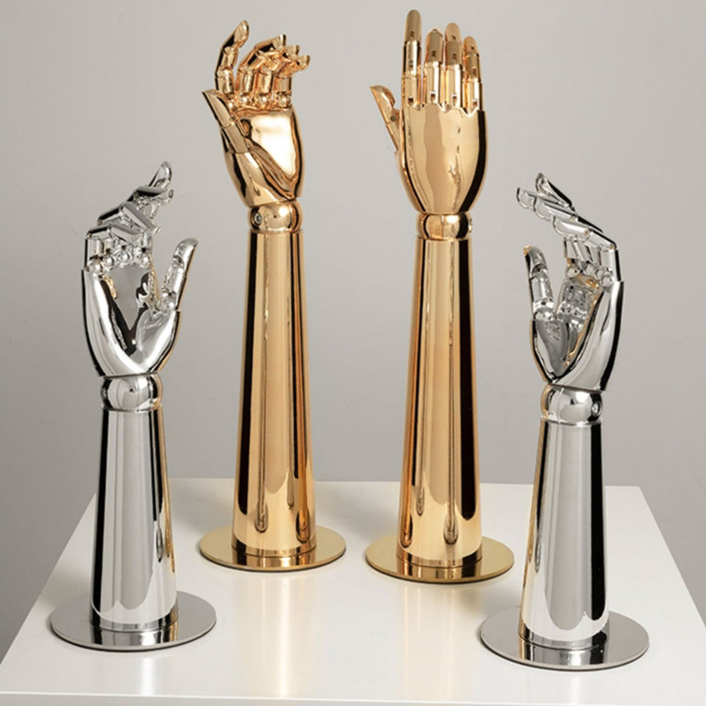 Four gold and chrome silver electroplated mannequin hand display stands with round bases