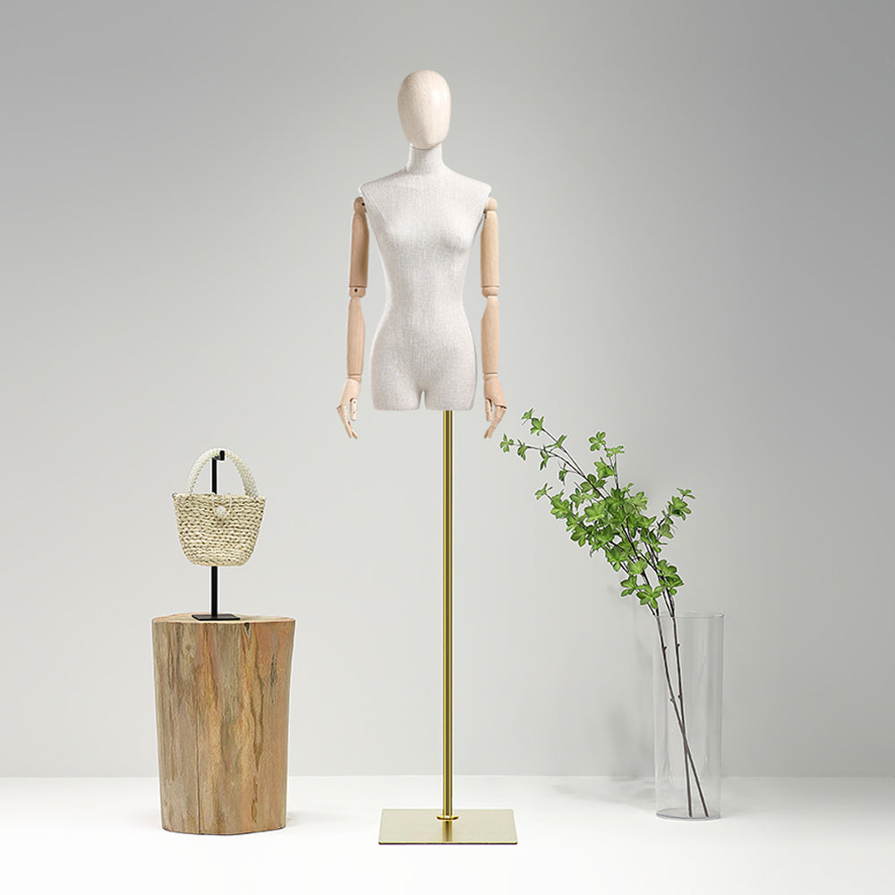 a mannequin is standing next to a vase with a plant in it