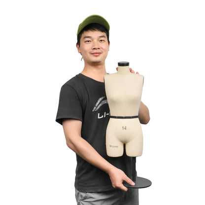 a man holding a mannequin wearing a hat