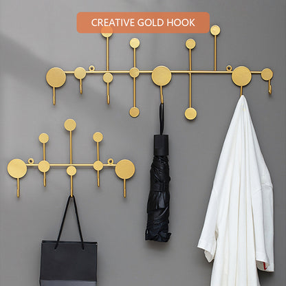 Luxury metal wall hooks in modern gold design for entryway coat and key storage.