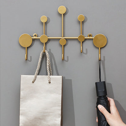 Luxury metal wall hooks in modern gold design for entryway coat and key storage.