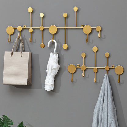 Luxury metal wall hooks in modern gold design for entryway coat and key storage.