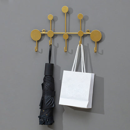 Luxury metal wall hooks in modern gold design for entryway coat and key storage.