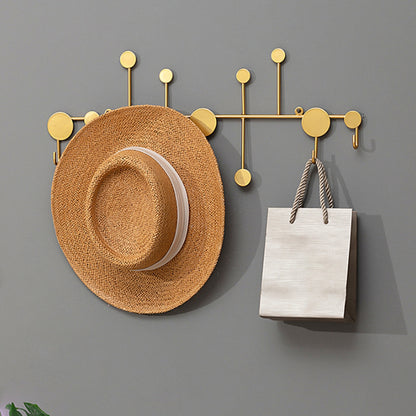 Luxury metal wall hooks in modern gold design for entryway coat and key storage.